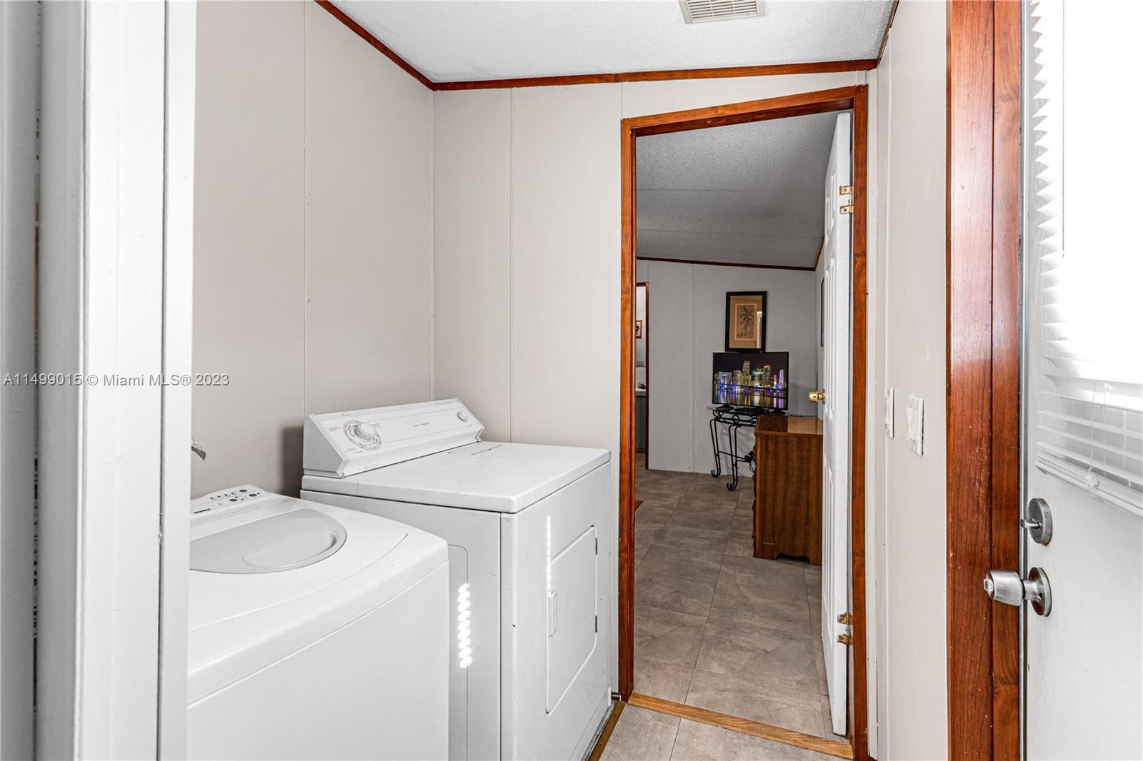 35250 Southwest 177th Court, Unit 77 Homestead, FL 33034 - Photo 15 of 30 a view of a hallway with washer and dryer