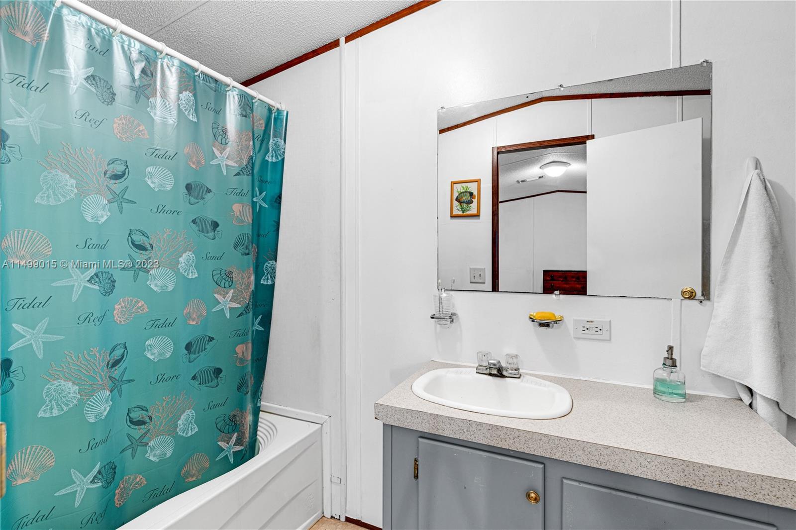 35250 Southwest 177th Court, Unit 77 Homestead, FL 33034 - Photo 19 of 30 a bathroom with a sink and a mirror