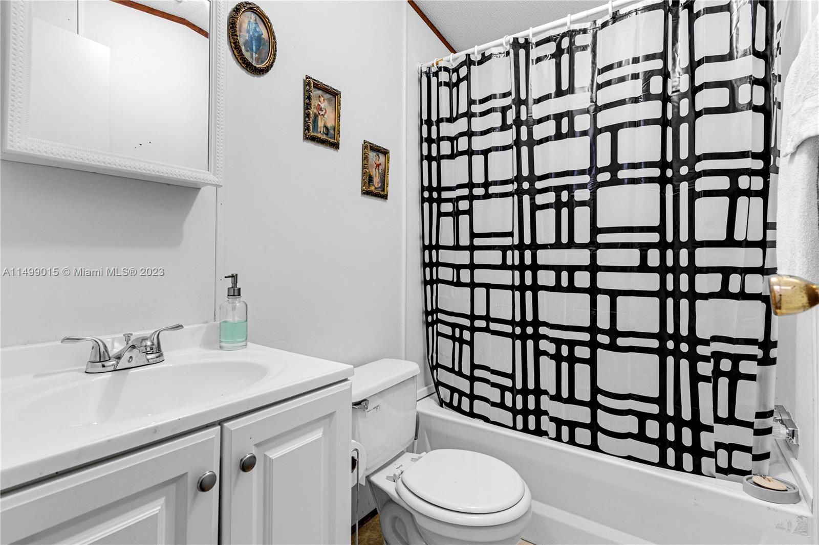 35250 Southwest 177th Court, Unit 77 Homestead, FL 33034 - Photo 22 of 30 a bathroom with a sink a toilet and shower