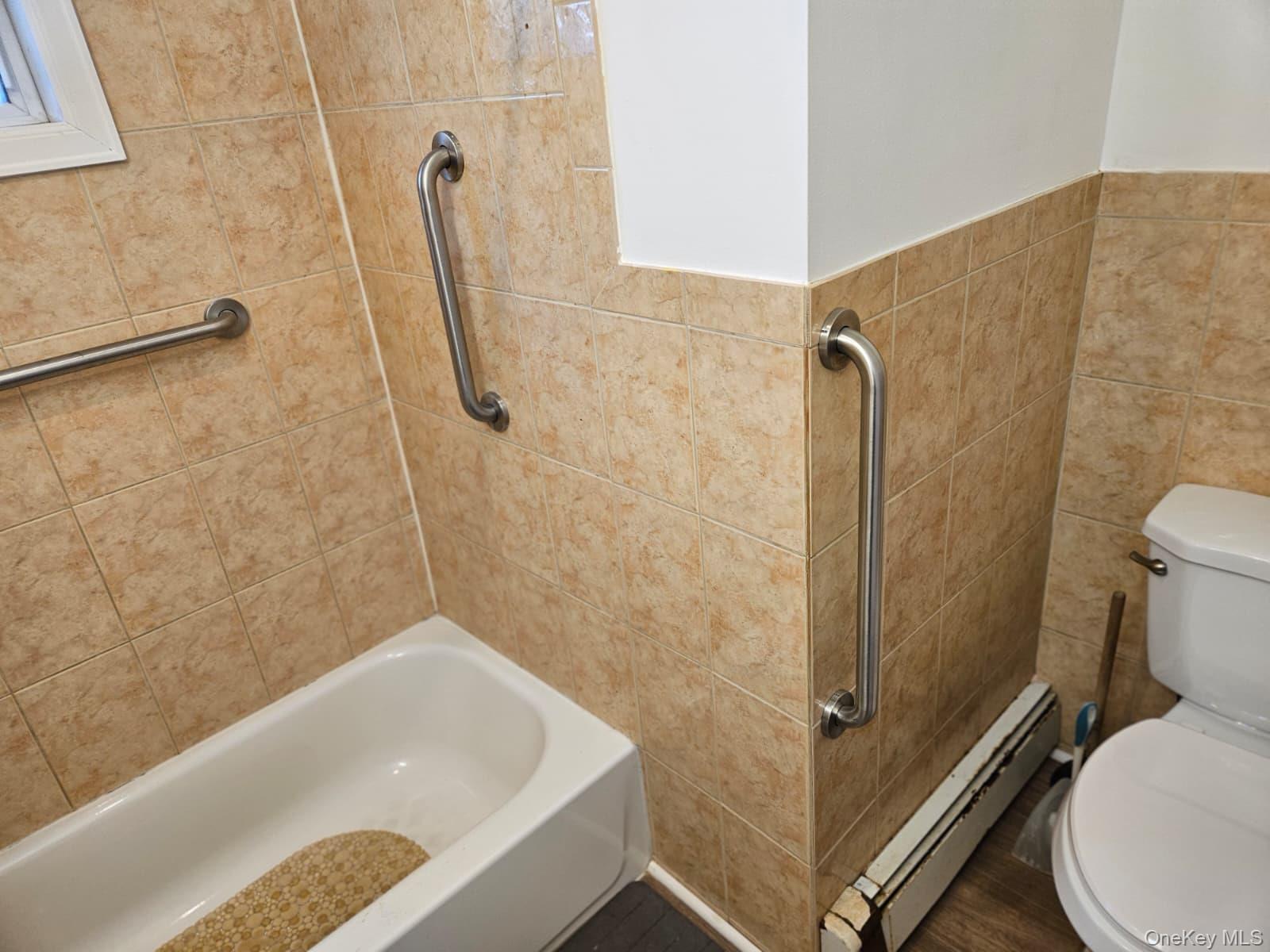 56 Applegate Drive Central Islip, NY 11722 - Photo 13 of 33 a bathroom with a white bath tub and a shower
