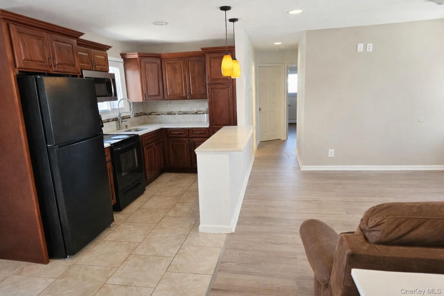 56 Applegate Drive Central Islip, NY 11722 - Photo 15 of 33 a kitchen with stainless steel appliances granite countertop a refrigerator a stove a sink and a refrigerator