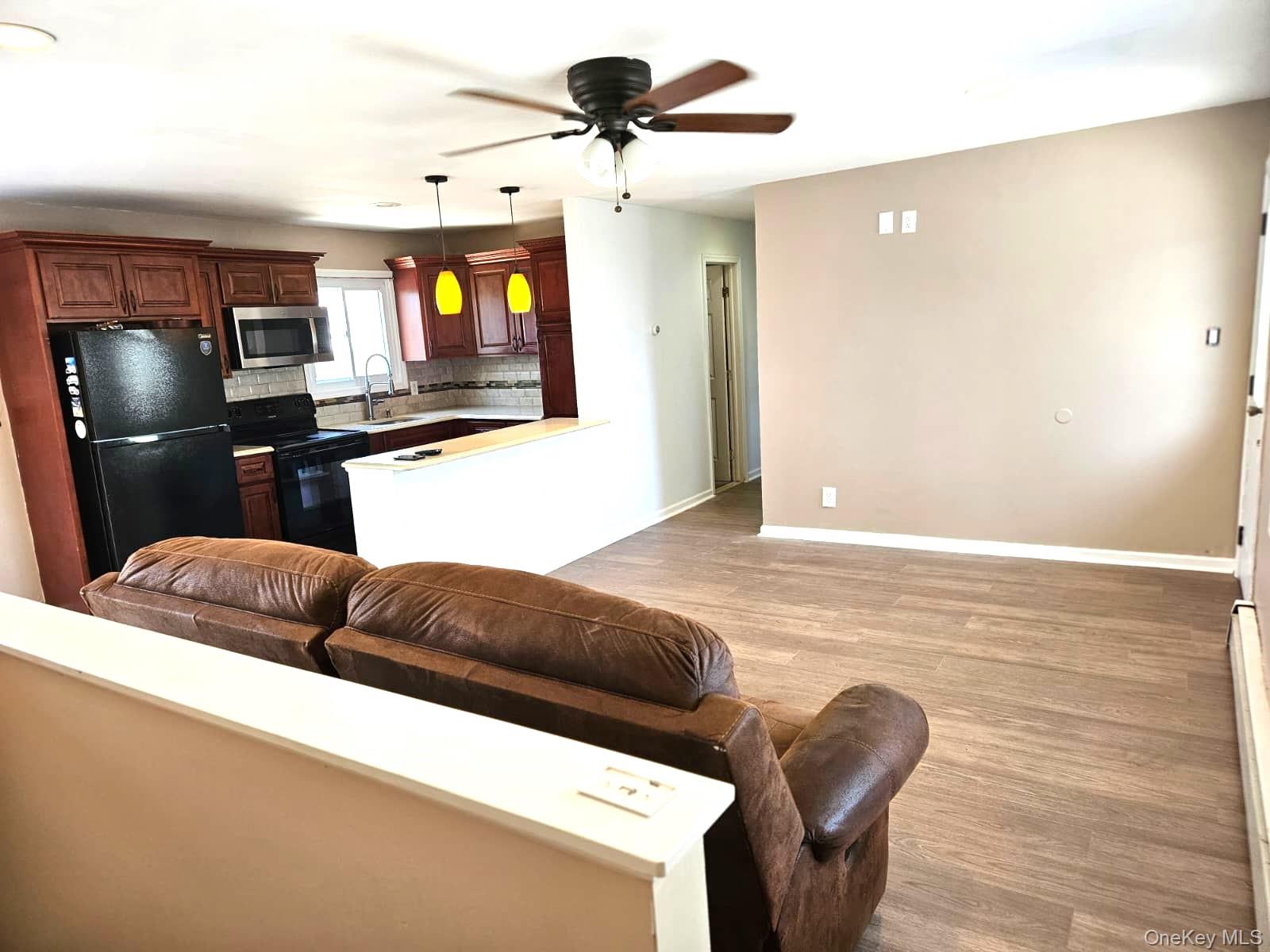 56 Applegate Drive Central Islip, NY 11722 - Photo 17 of 33 a living room with furniture and a flat screen tv