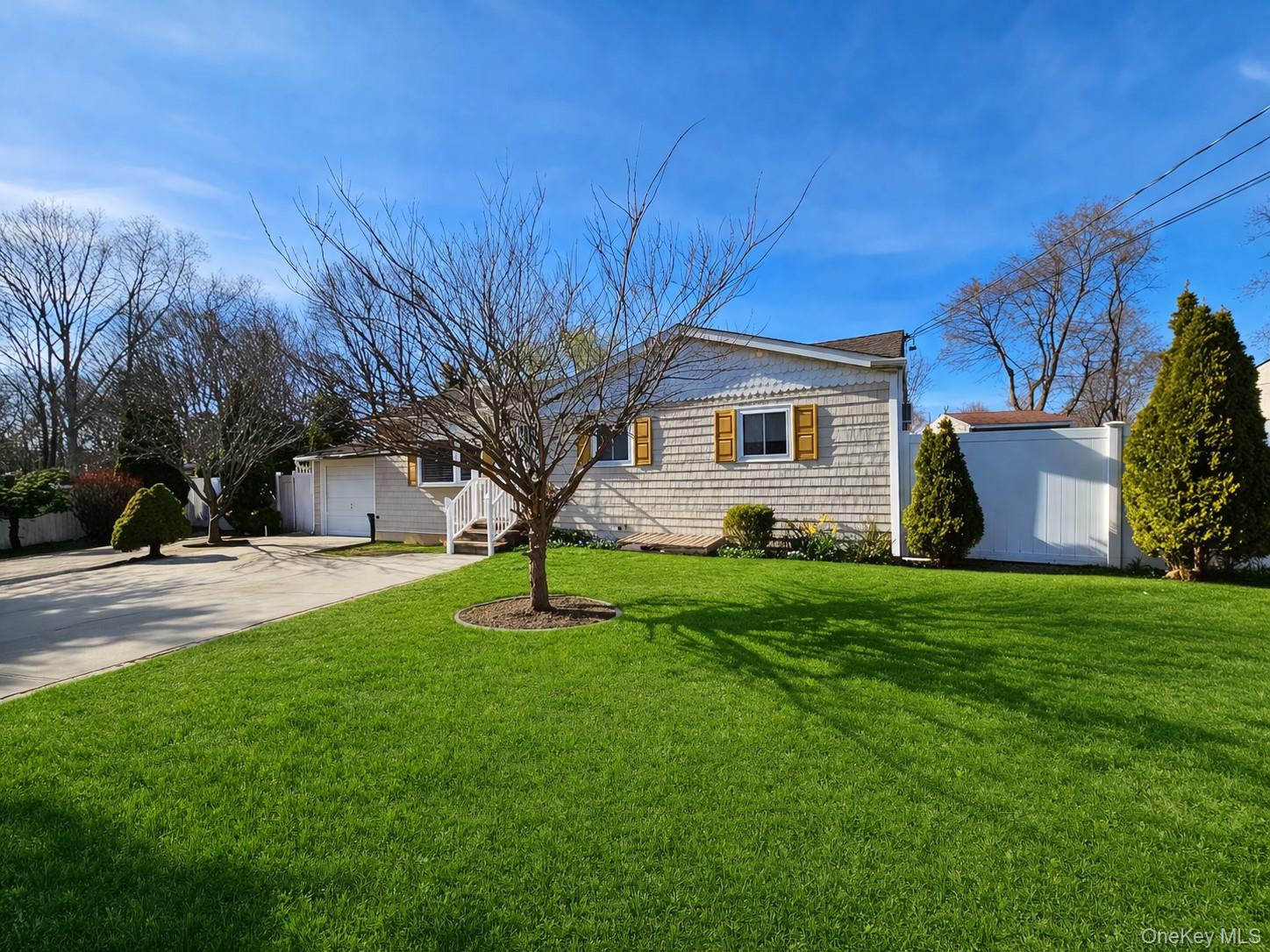 56 Applegate Drive Central Islip, NY 11722 - Photo 2 of 33 a front view of house with yard and trees