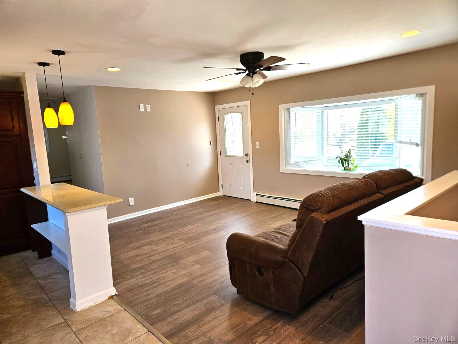 56 Applegate Drive Central Islip, NY 11722 - Photo 23 of 33 a living room with furniture and a chandelier