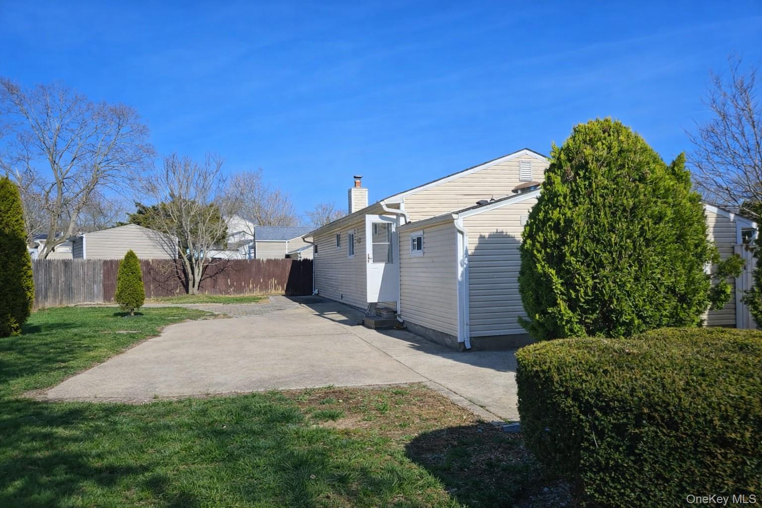 56 Applegate Drive Central Islip, NY 11722 - Photo 31 of 33 a view of a back yard with green space and plants
