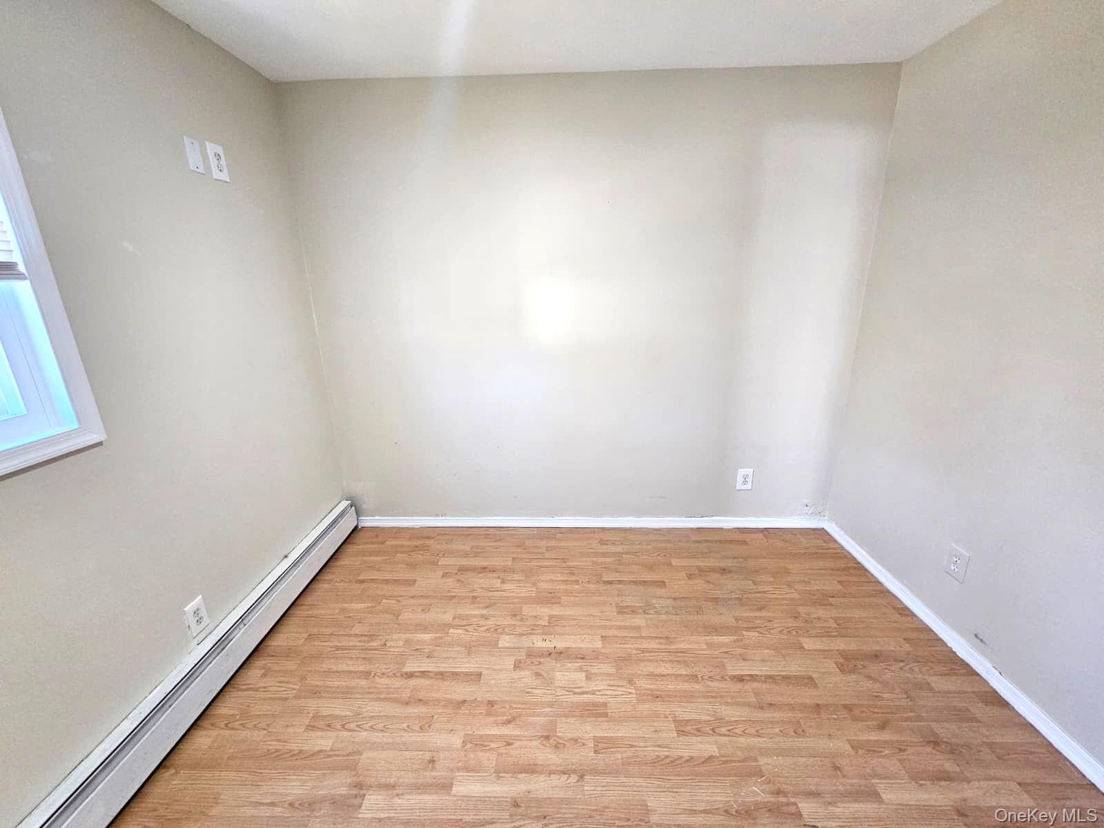 56 Applegate Drive Central Islip, NY 11722 - Photo 7 of 33 a view of an empty room and wooden floor