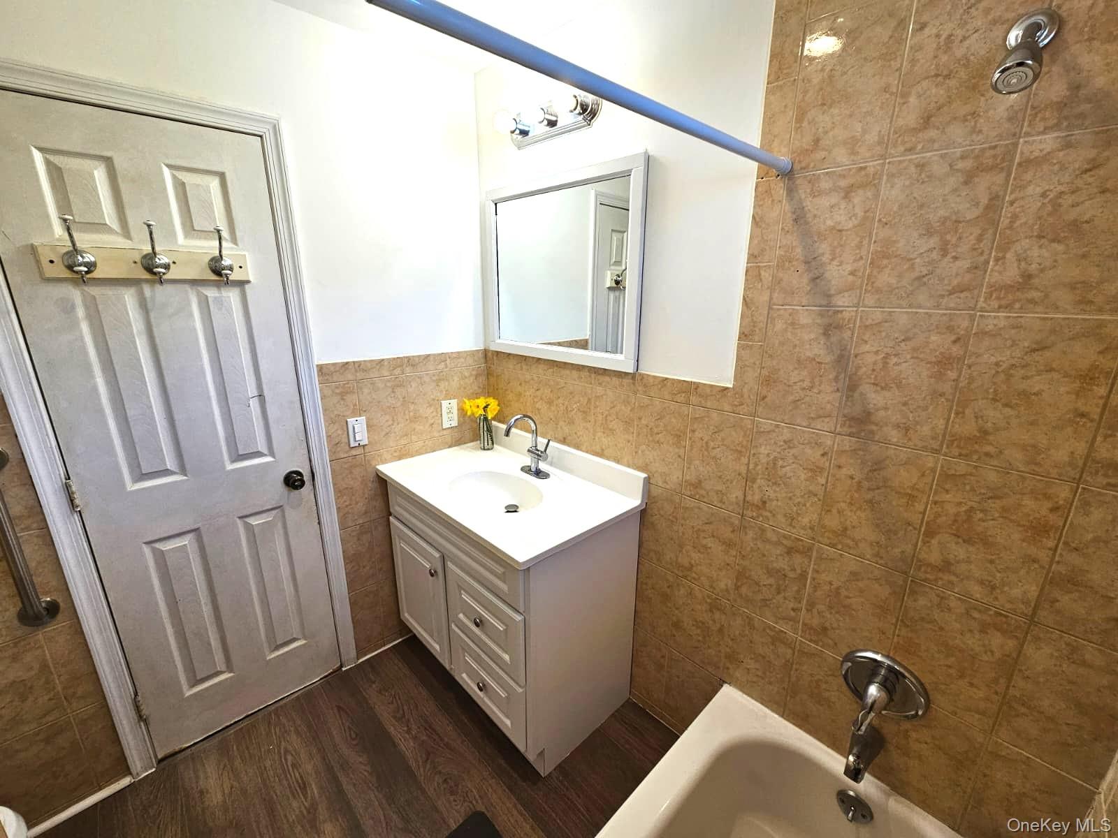 56 Applegate Drive Central Islip, NY 11722 - Photo 10 of 33 a bathroom with a sink a mirror and a shower