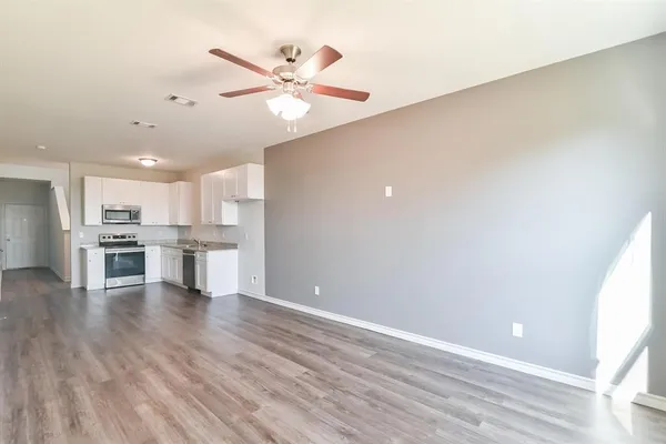 a view of kitchen with wooden floor and window