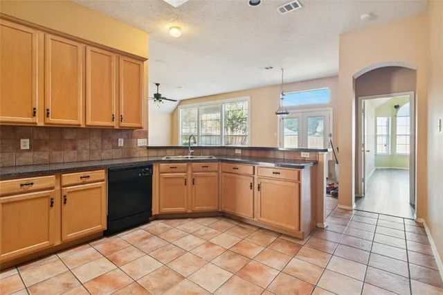 a kitchen with a sink cabinets and window