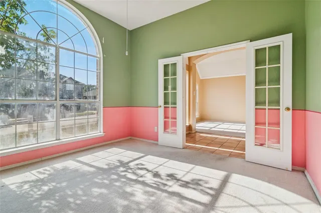 a view of a big room with wooden floor and windows