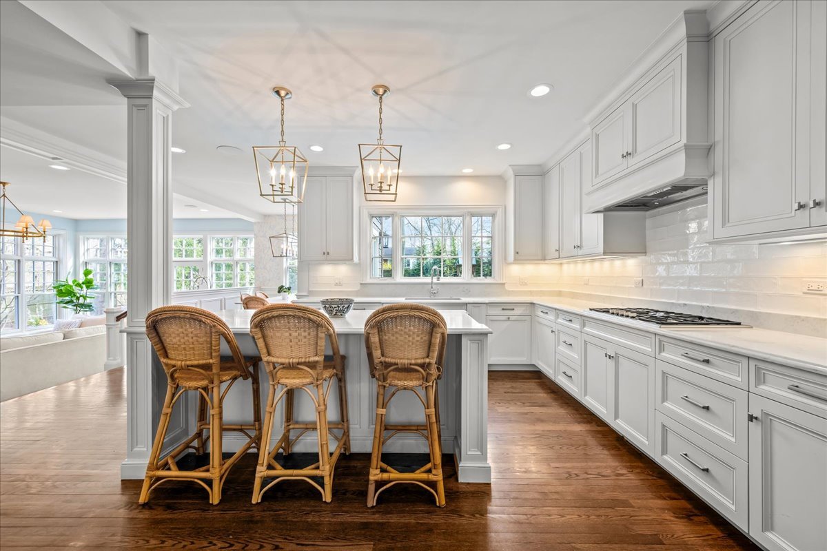 129 Ravine Forest Drive Lake Bluff, IL 60044 - Photo 15 of 50 a kitchen with granite countertop a table chairs stove and white cabinets
