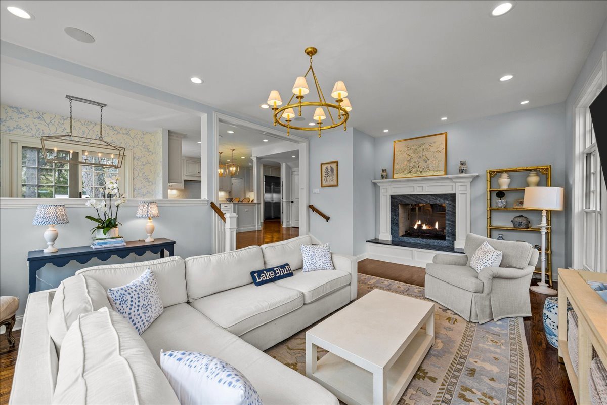 129 Ravine Forest Drive Lake Bluff, IL 60044 - Photo 24 of 50 a living room with furniture a fireplace and a chandelier