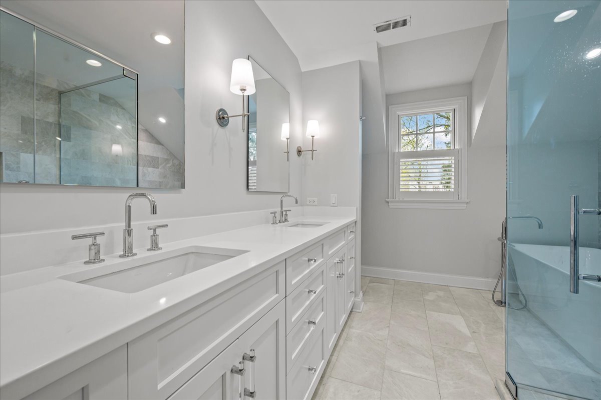 129 Ravine Forest Drive Lake Bluff, IL 60044 - Photo 32 of 50 a spacious bathroom with a double vanity sink a mirror and a bathtub
