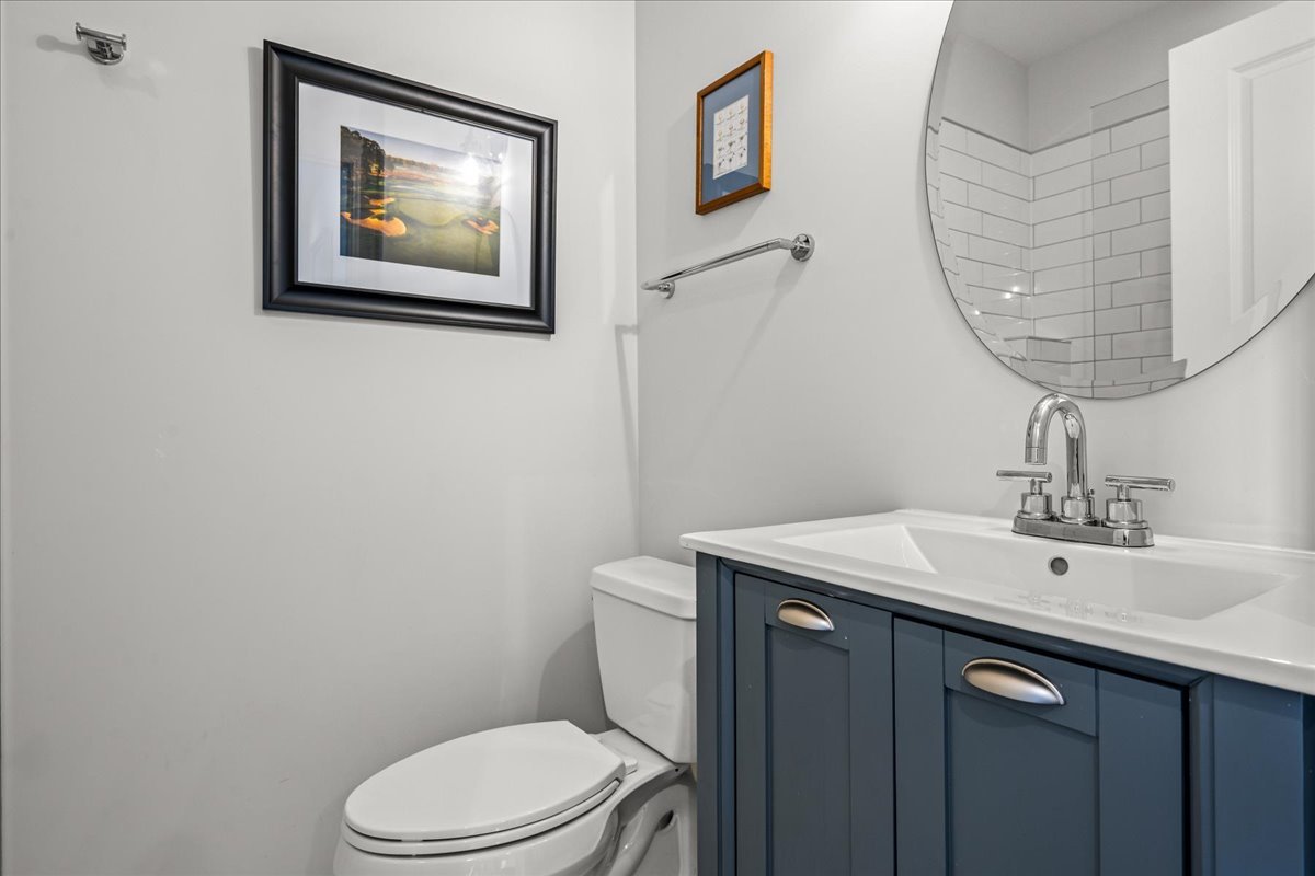 129 Ravine Forest Drive Lake Bluff, IL 60044 - Photo 39 of 50 a bathroom with a toilet a sink and mirror