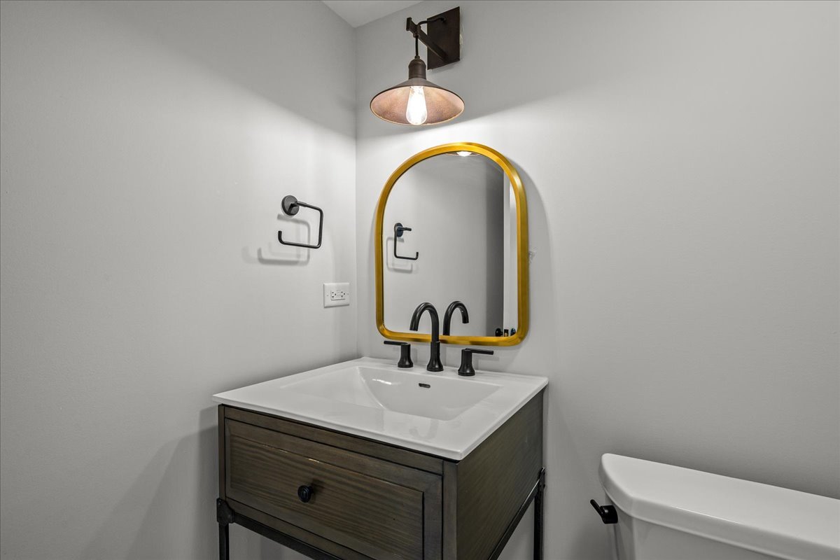 129 Ravine Forest Drive Lake Bluff, IL 60044 - Photo 46 of 50 a bathroom with a sink mirror and toilet