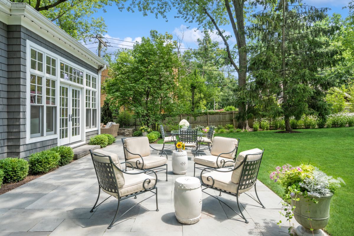 129 Ravine Forest Drive Lake Bluff, IL 60044 - Photo 47 of 50 a view of a patio with table and chairs potted plants and a large tree