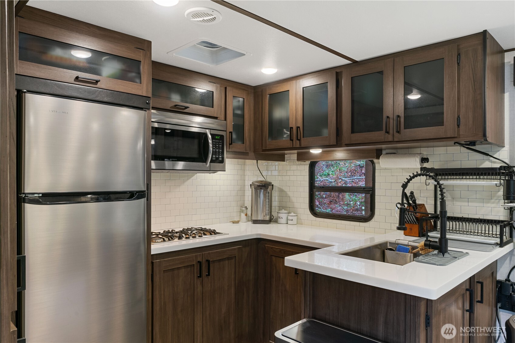 13620 Kelly Road Northeast Duvall, WA 98019 - Photo 22 of 28 a kitchen with refrigerator a sink and cabinets
