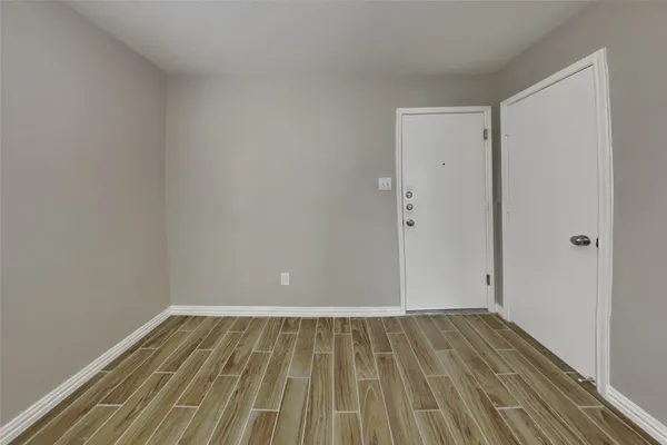 a view of room with wooden floor