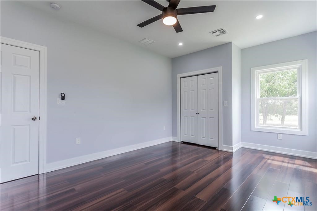 1110 North 42nd Street Temple, TX 76501 - Photo 22 of 32 a view of an empty room with wooden floor and a window