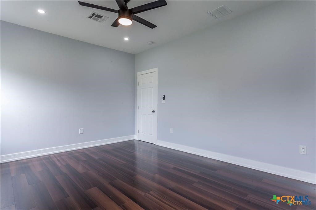 1110 North 42nd Street Temple, TX 76501 - Photo 23 of 32 a view of a room with wooden floor and a ceiling fan
