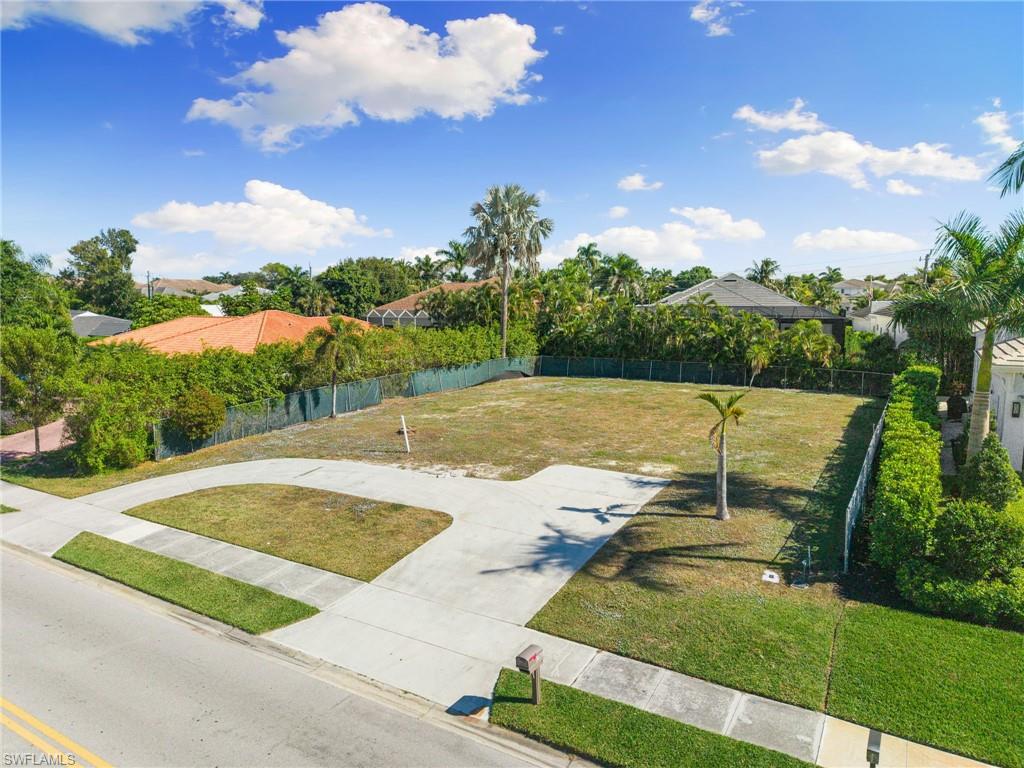 3670 Crayton Road Naples, FL 34103 - Photo 4 of 12 a view of a swimming pool with a yard