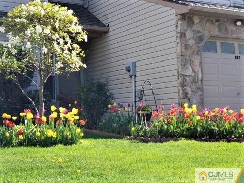 182 Nebula Road, Unit 182 Piscataway, NJ 08854 - Photo 2 of 23 a backyard of a house with lots of green space and outdoor seating