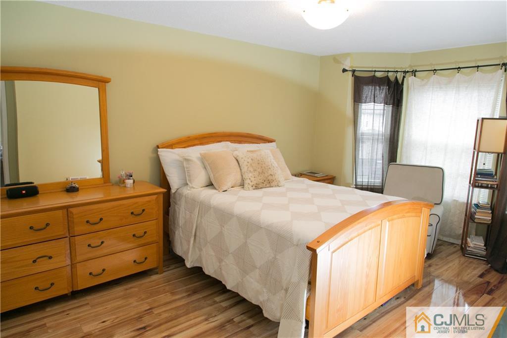 182 Nebula Road, Unit 182 Piscataway, NJ 08854 - Photo 11 of 23 a bedroom with a bed and a dresser in it