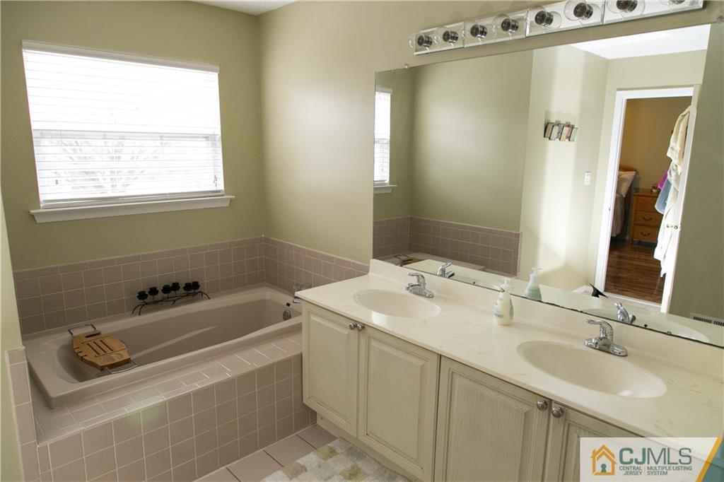 182 Nebula Road, Unit 182 Piscataway, NJ 08854 - Photo 12 of 23 a bathroom with a sink and a mirror
