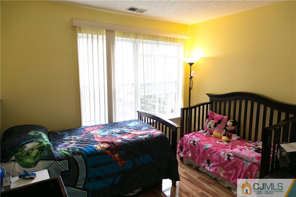 182 Nebula Road, Unit 182 Piscataway, NJ 08854 - Photo 13 of 23 a bedroom with a bed and a window