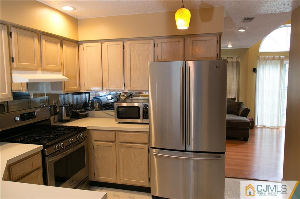 182 Nebula Road, Unit 182 Piscataway, NJ 08854 - Photo 3 of 23 a kitchen with a refrigerator and a stove