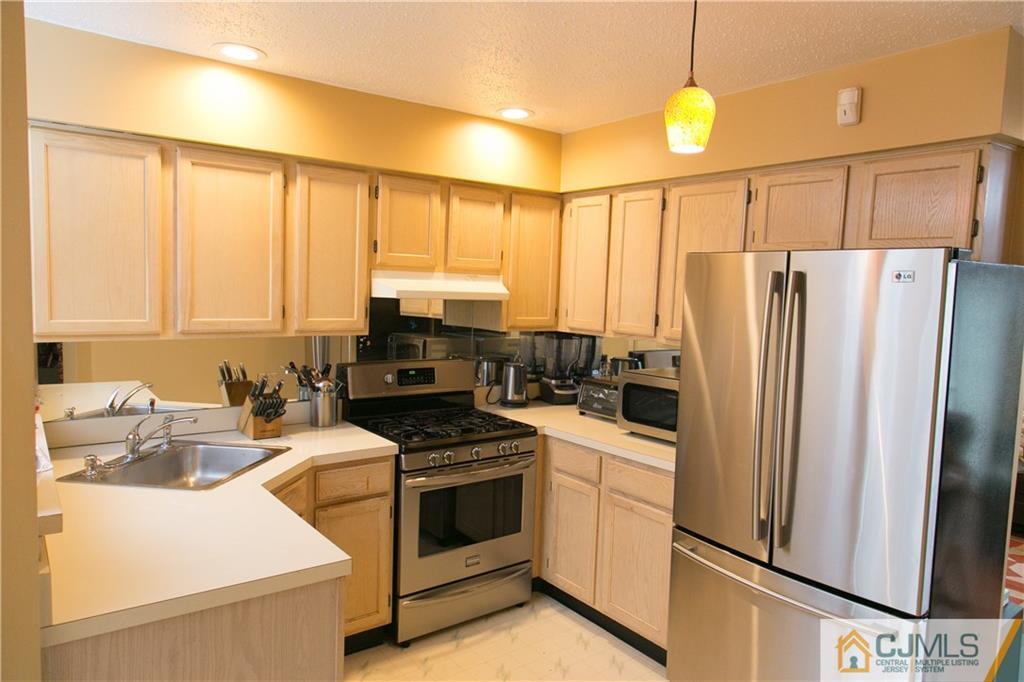 182 Nebula Road, Unit 182 Piscataway, NJ 08854 - Photo 4 of 23 a kitchen with stainless steel appliances a refrigerator sink and stove