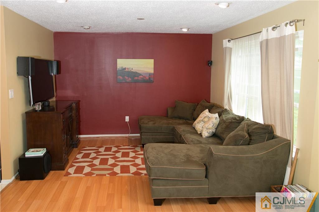 182 Nebula Road, Unit 182 Piscataway, NJ 08854 - Photo 6 of 23 a living room with furniture and a flat screen tv