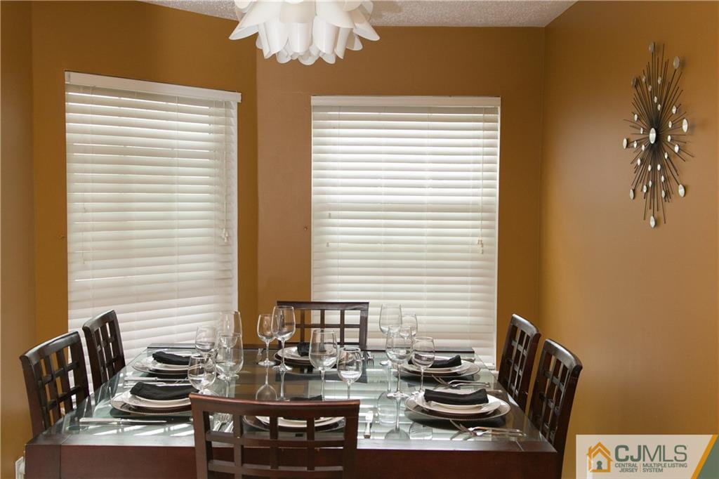 182 Nebula Road, Unit 182 Piscataway, NJ 08854 - Photo 7 of 23 a kitchen with a table and chairs in it