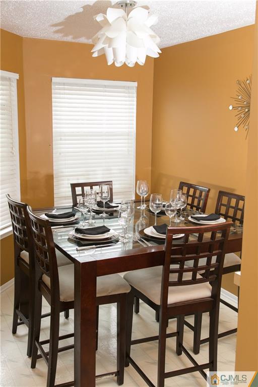 182 Nebula Road, Unit 182 Piscataway, NJ 08854 - Photo 8 of 23 a view of a dining room with furniture and window