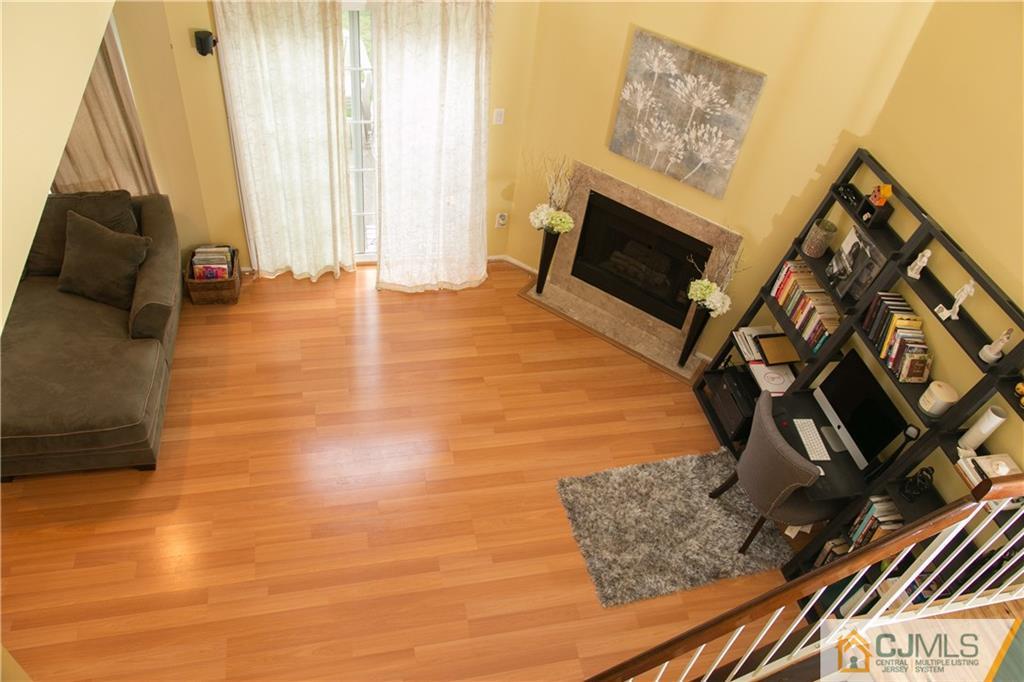 182 Nebula Road, Unit 182 Piscataway, NJ 08854 - Photo 9 of 23 a view of an empty room with wooden floor and a window