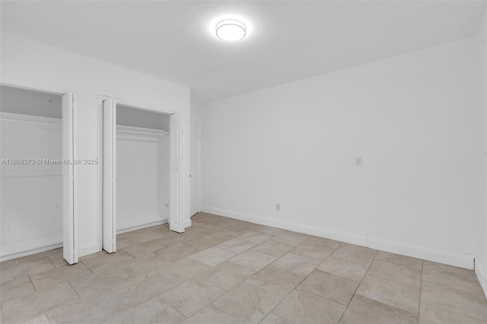 7424 Byron Avenue, Unit 2B Miami Beach, FL 33141 - Photo 12 of 25 an empty room with an entryway