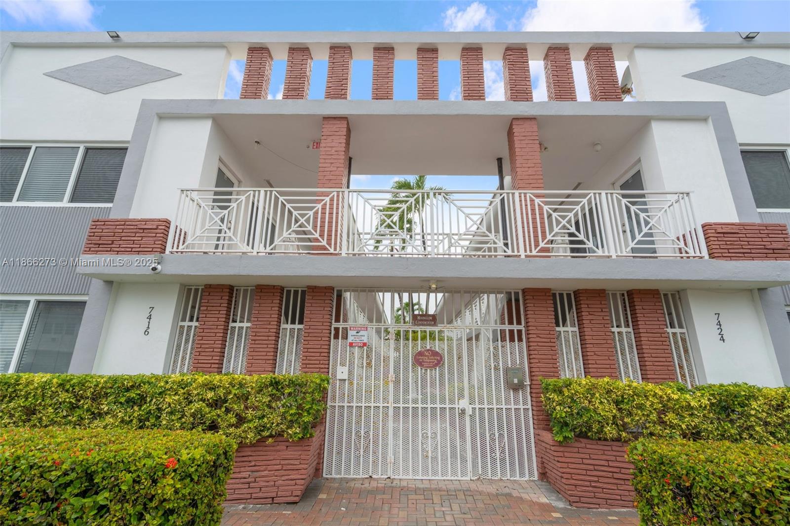 7424 Byron Avenue, Unit 2B Miami Beach, FL 33141 - Photo 15 of 25 a front view of a house with a garden