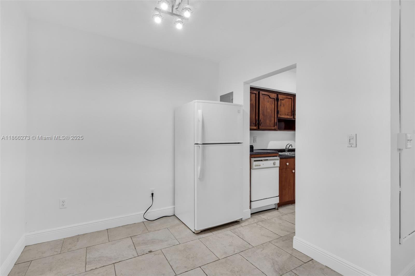 7424 Byron Avenue, Unit 2B Miami Beach, FL 33141 - Photo 6 of 25 a view of kitchen with refrigerator and microwave