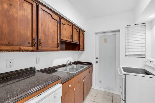 a kitchen with stainless steel appliances granite countertop a sink and a cabinets