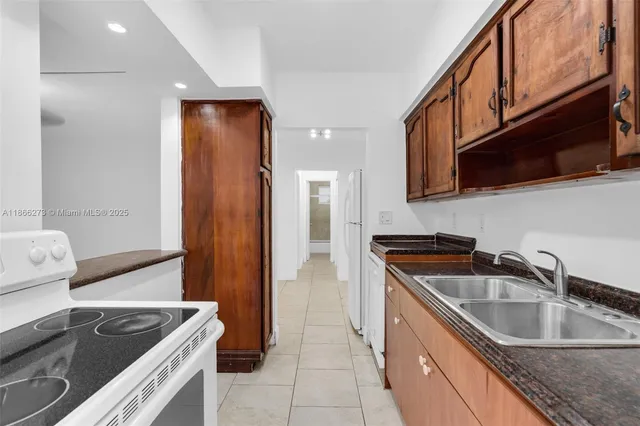 a kitchen that has a sink and a stove
