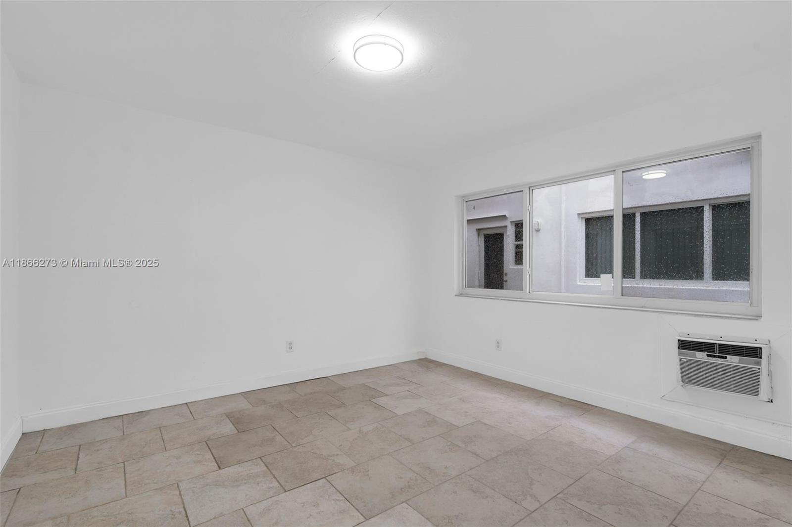 7424 Byron Avenue, Unit 2B Miami Beach, FL 33141 - Photo 10 of 25 a view of an empty room with a window