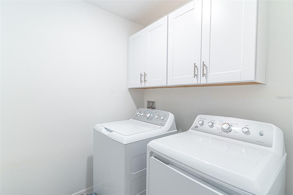 7014 Ripple Pond Loop Zephyrhills, FL 33541 - Photo 13 of 40 a view of storage and utility room with washer and dryer