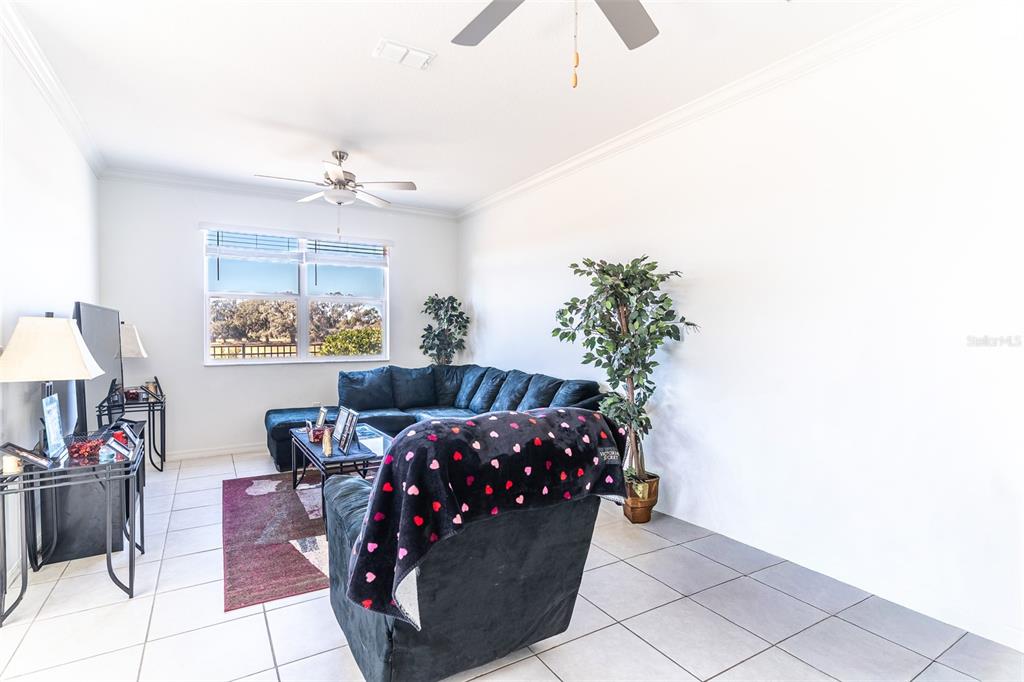 7014 Ripple Pond Loop Zephyrhills, FL 33541 - Photo 2 of 40 a bed room with a bed and a chandelier