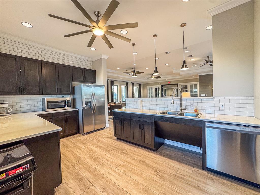 7014 Ripple Pond Loop Zephyrhills, FL 33541 - Photo 35 of 40 a kitchen with stainless steel appliances granite countertop a sink a stove and a refrigerator