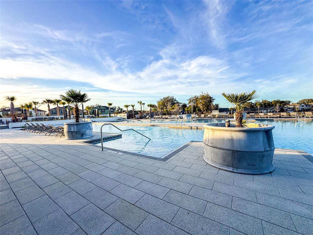 7014 Ripple Pond Loop Zephyrhills, FL 33541 - Photo 39 of 40 a view of a swimming pool with an outdoor seating