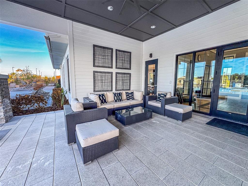 7014 Ripple Pond Loop Zephyrhills, FL 33541 - Photo 40 of 40 a living room with furniture and a floor to ceiling window
