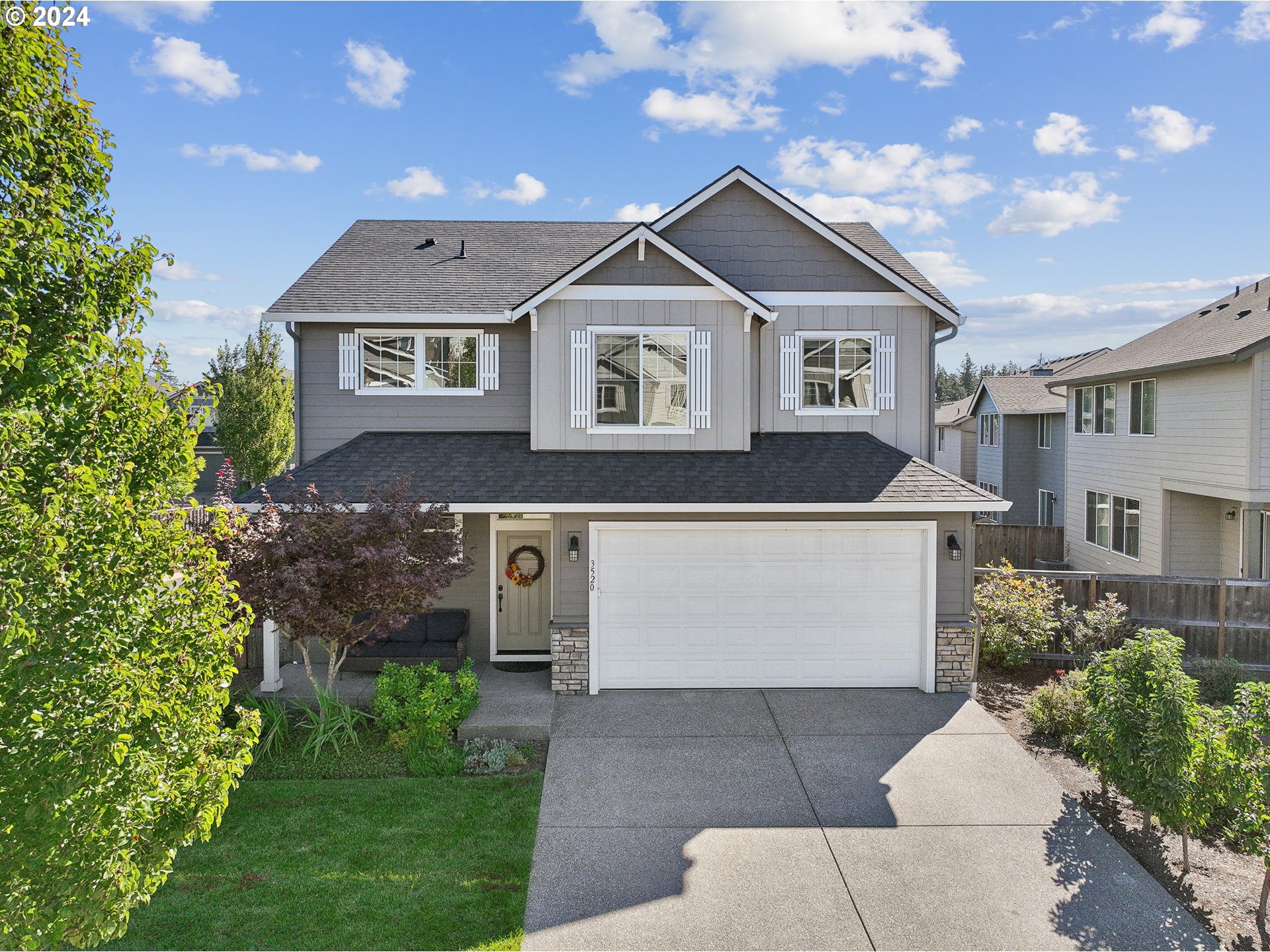 3520 Northeast Spruce Drive Camas, WA 98607 - Photo 1 of 38 a front view of a house with a garden