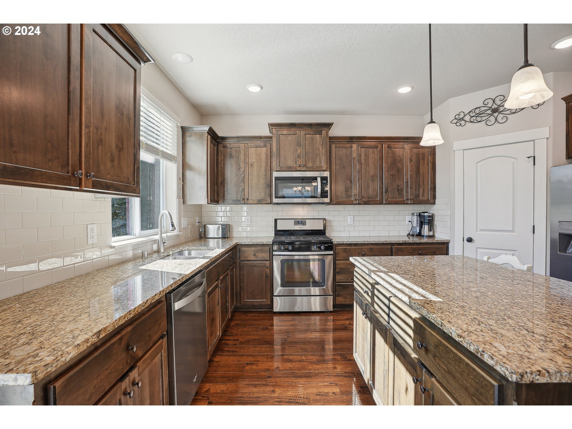 3520 Northeast Spruce Drive Camas, WA 98607 - Photo 15 of 38 a kitchen with kitchen island granite countertop a sink stove cabinets and refrigerator