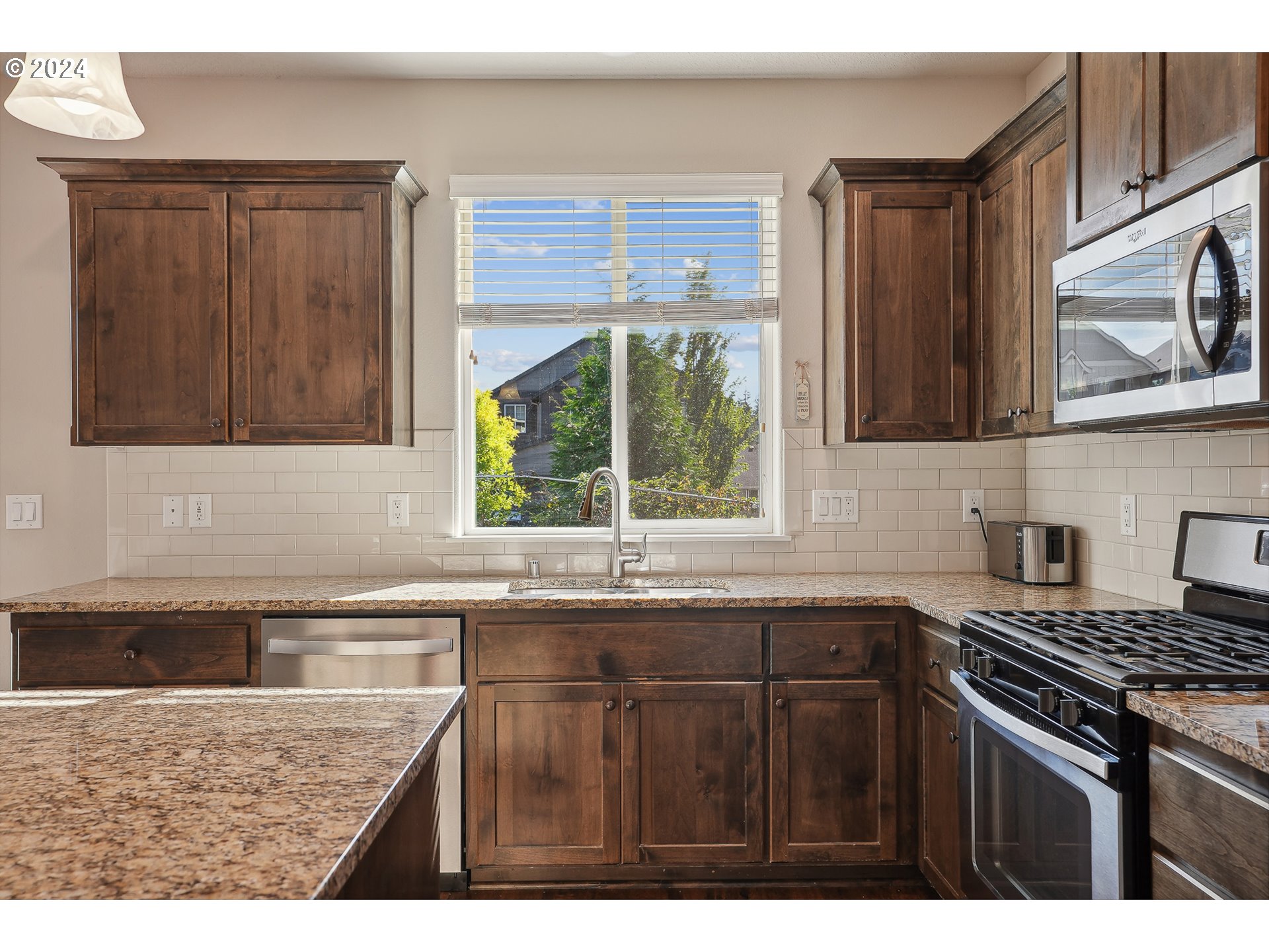 3520 Northeast Spruce Drive Camas, WA 98607 - Photo 16 of 38 a kitchen with stainless steel appliances granite countertop a sink stove and microwave