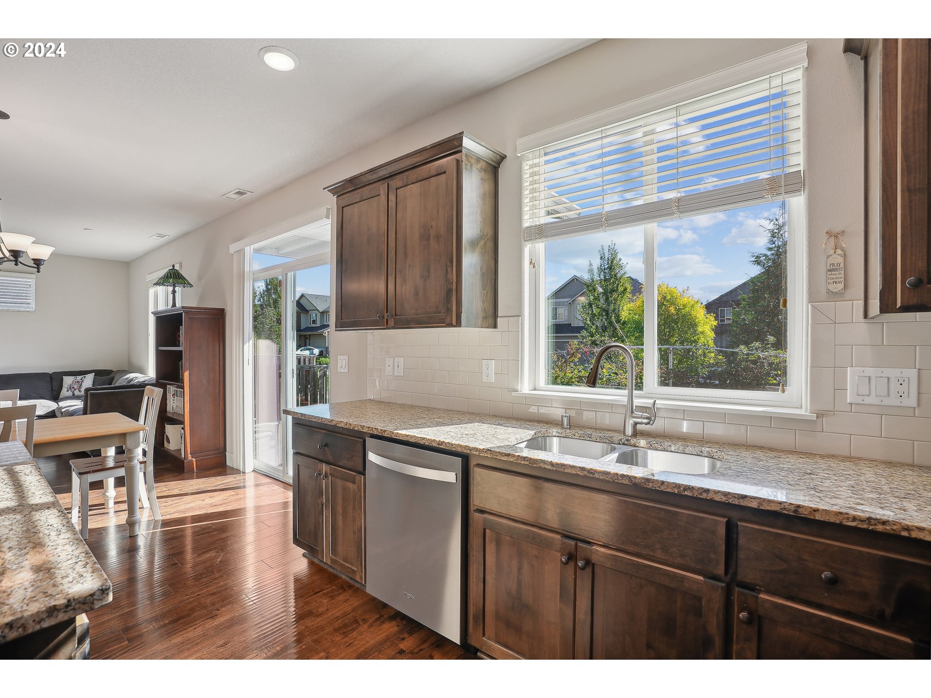3520 Northeast Spruce Drive Camas, WA 98607 - Photo 17 of 38 a kitchen with a sink a counter top space and living room view